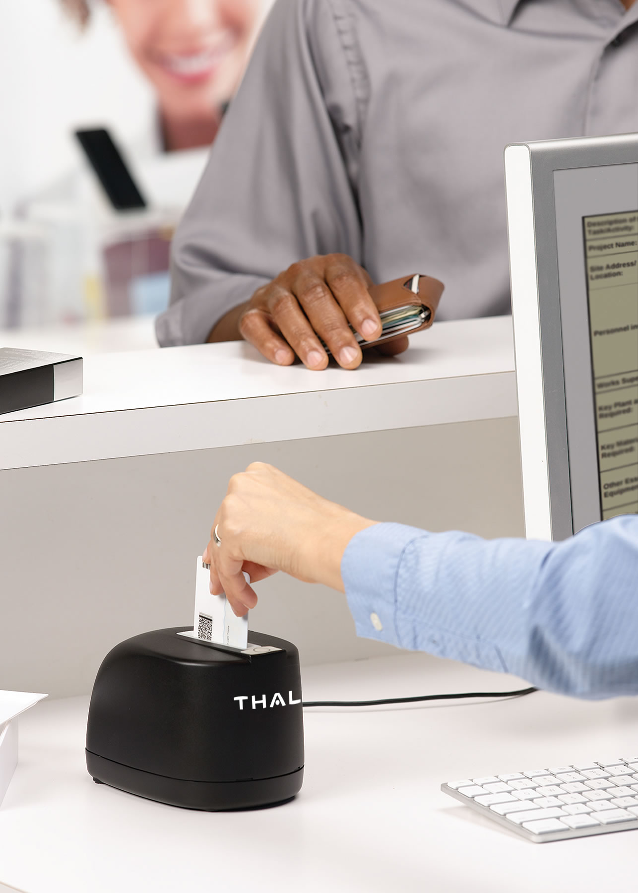 Thales CR5400 in use at a retail counter, ID card being dropped into the reader